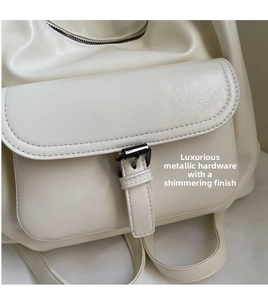 Detail of off-white leather backpack featuring gunmetal buckle and premium matte texture