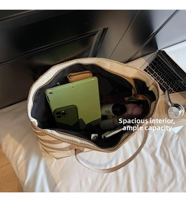 Spacious striped woven tote bag showing internal storage for tablets and daily essentials