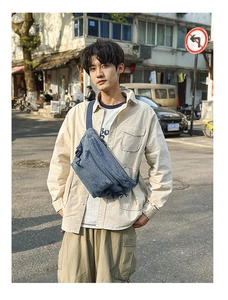 Outdoor street style shot of a casual blue denim crossbody chest bag for men