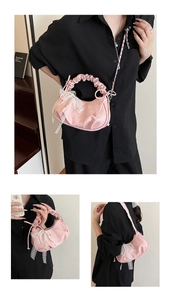 Detail of pink patent leather cloud bag with white lace bow and pearl charm