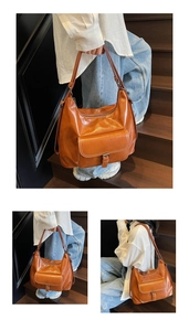 Detail of caramel faux leather tote bag showing glossy texture and metal buckle pocket