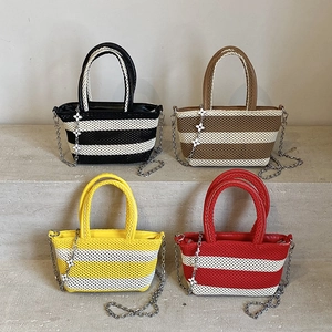 Set of four woven striped tote bags in black, brown, yellow, and red with floral charms
