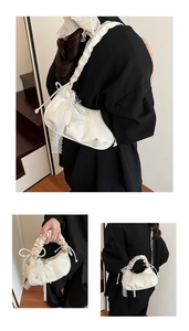 Detailed macro view of cream ruffled cloud bag with lace trim and pearl bead accents