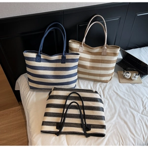 Three striped woven tote bags in blue, brown, and black colors for summer beach vacations