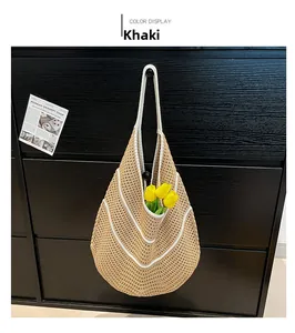 Detailed view of khaki crochet woven bag with white piping and hollow knit texture