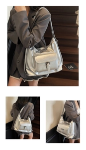 Macro view of metallic silver tote bag with buckle pocket detail and glossy leather texture