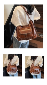 Detail of caramel brown tote bag featuring front flap pocket and adjustable metal belt buckle