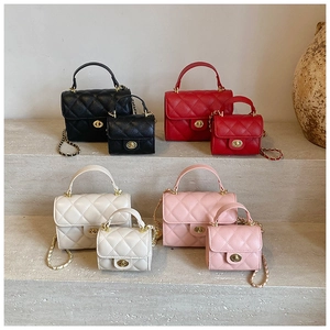 Quilted mini square bags in four colors with gold locks and chain straps on stone steps