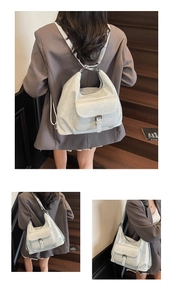 Detail of off-white tote bag showing adjustable straps for backpack and shoulder use