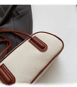 Detail shot of vintage canvas bowling bag with brown leather stitching and soft texture