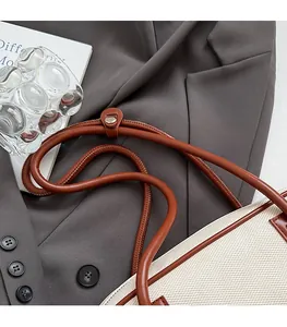 Detail showing the comfortable leather shoulder strap and metal rivets of the bowling bag
