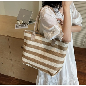 Side view of striped woven tote bag featuring brown and white texture for summer beach