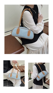 Detail views of light blue textured denim shoulder bag with brown leather handles