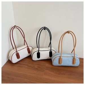 Three stylish cylinder shoulder bags in white and blue denim textures on a wooden platform