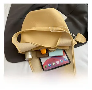 Internal view of the yellow leather bucket bag showing storage for tablet and essentials