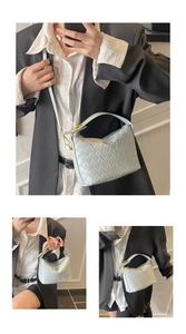 Detail of mint green woven crossbody bag with gold hardware and detachable strap