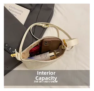 Internal capacity of the beige woven crossbody bag showing space for phone and cosmetics