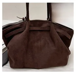 Close-up of vintage dark brown suede tote bag featuring soft matte texture and spacious design