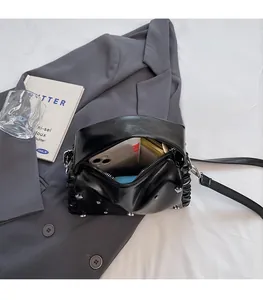 Detailed interior view of a black rivet bag showing large capacity for essentials