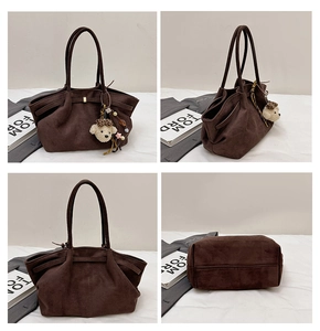 Detail view of brown suede tote bag featuring a cute leopard print bear charm accessory