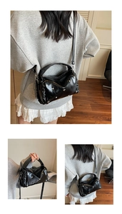 Detail of black pleated crossbody bag with silver heart studs and adjustable strap