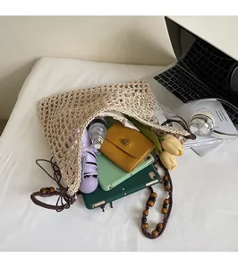 Flat lay of woven tote bag showing large capacity for umbrella, wallet and daily items