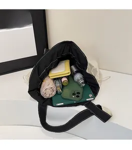 Vista dall'alto dello spazioso interno della borsa tote in nylon con coulisse per tablet e kit