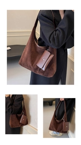 Detail of dark brown suede hobo tote bag featuring a matching detachable card pouch