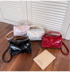 Group shot of colorful tote bags with butterfly hardware and chic heart rivet accents