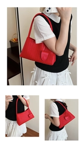 Macro detail of red woven leather shoulder bag showing the premium Intrecciato craft