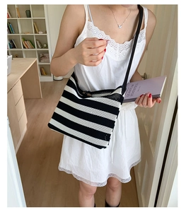 Chic black and white striped woven tote bag with slim shoulder strap for daily wear