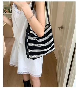 Close-up of black and white striped mesh knit tote bag showing breathable woven texture