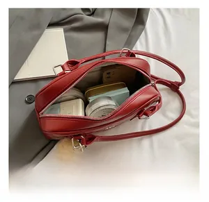 Interior view of red quilted bowling bag showing spacious capacity and cute bear charm