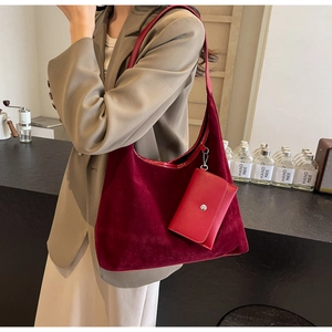 Detail of burgundy velvet tote bag with matching snap pouch for casual commute
