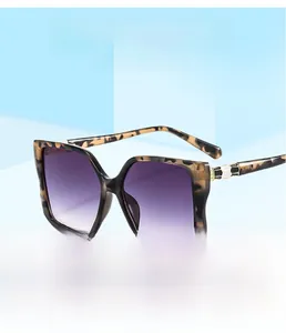 Detail view of square leopard print frames with purple gradient lenses and metal hinges