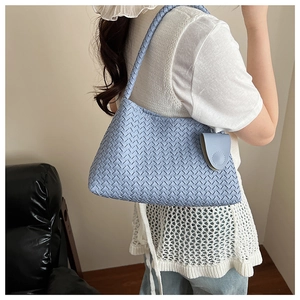 Detail of light blue woven hobo bag with matching mini coin purse attachment