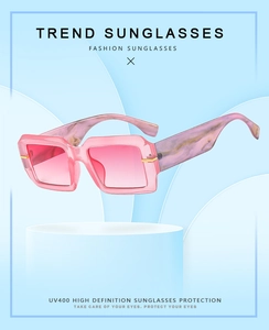 Detailed side view of pink rectangle sunglasses with marble pattern temples and UV400 lens