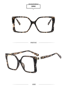 Detail view of square tortoiseshell sunglasses with textured snake scale metal hinges