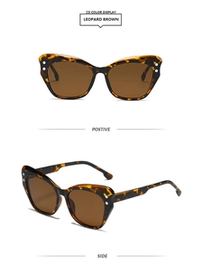 Detail view of leopard cat-eye sunglasses with brown lenses and silver rivet accents