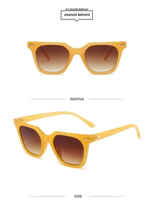 Detail of vintage thick orange frames and brown gradient lenses with silver rivets