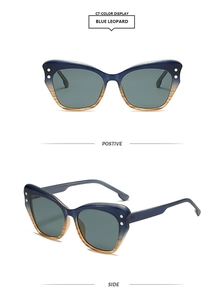 Detail of blue leopard cat-eye sunglasses with silver metal dots and gradient lenses