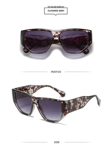 Detailed view of rectangle sunglasses in tortoiseshell frame with gradient grey lenses