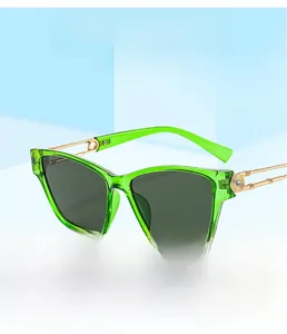 Detailed view of emerald green resin sunglasses frame with crystal-embellished gold temples