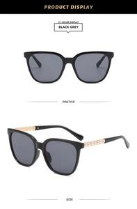 Detail of square black sunglasses featuring gold wavy temples with pearl embellishments