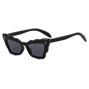 Black cat eye butterfly sunglasses with wavy frames and gold rivets on a white background