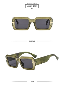 Macro view of green marble texture frames with dark gray lenses and gold accents