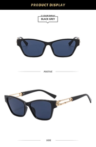 Detail of black cat-eye sunglasses with gold hollowed temples and crystal accents