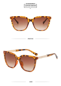 Detail of square leopard brown sunglasses with side pearls and brown gradient lenses