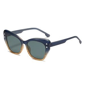 Y2K cat eye sunglasses with gradient blue frames and dark green lenses in top-down view