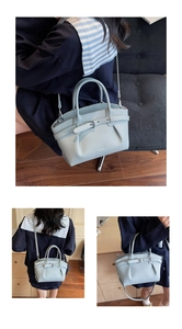 Detail of light blue bucket bag with lychee texture and adjustable shoulder strap